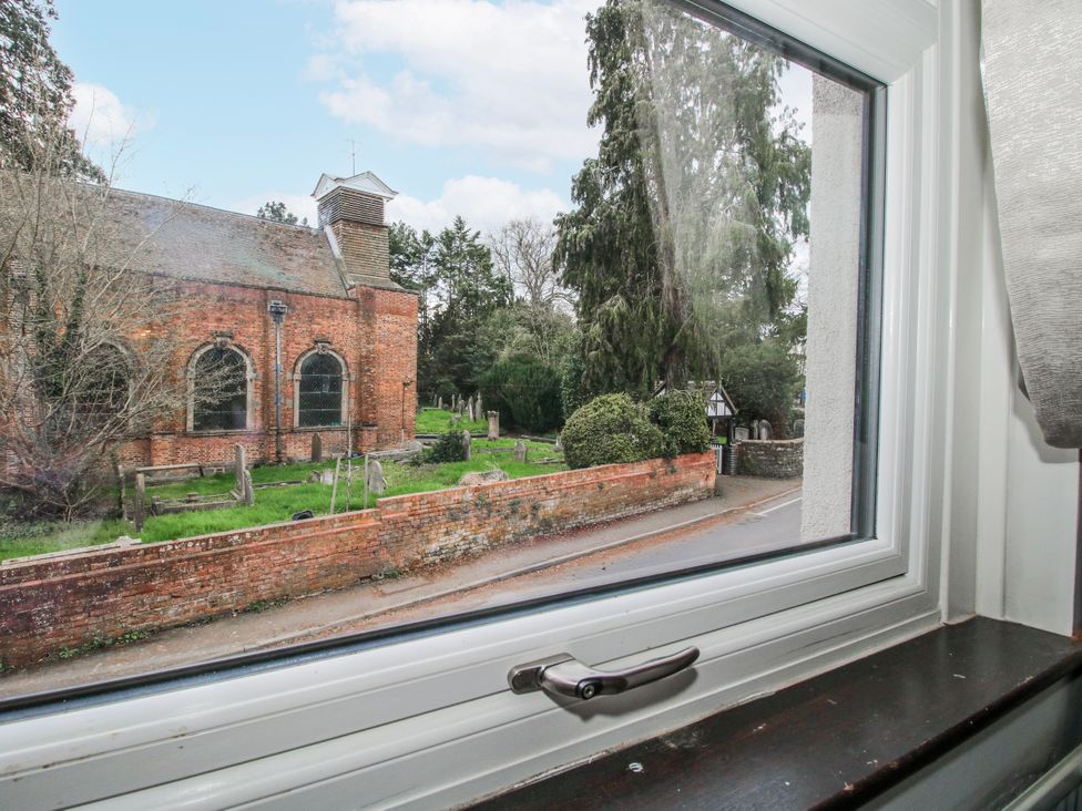 A view from a window showing a church and graves at Corner House Minsterley