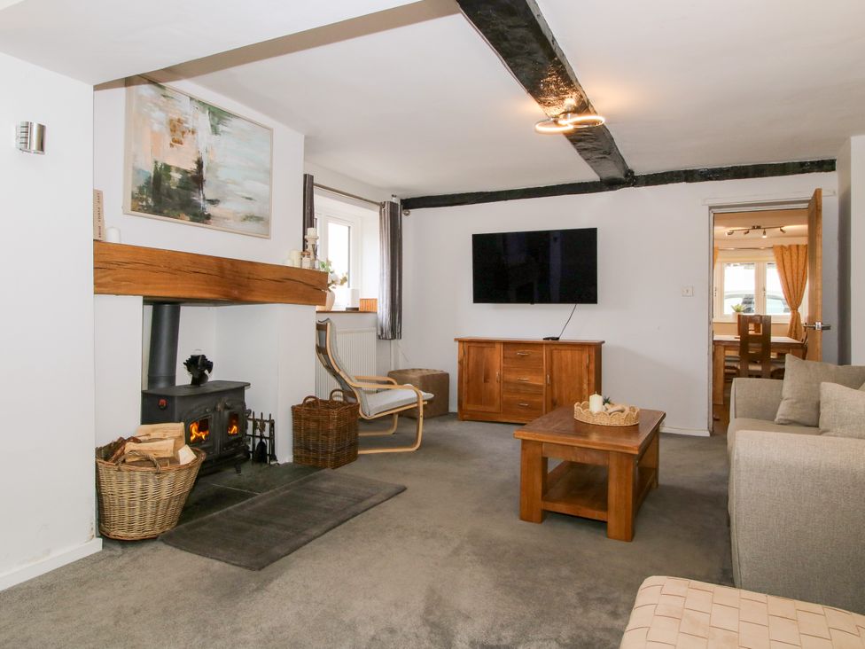 A living room with a coffee table and television at Corner House in Minsterley