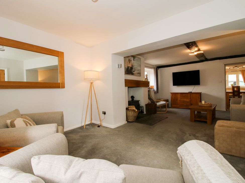 A living room with a sofa and television at Corner House Minsterley