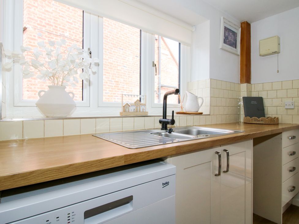 A kitchen with a sink and dishwasher at Corner House in Minsterley