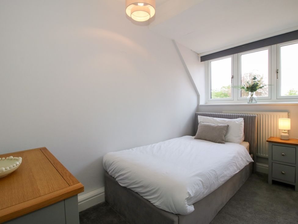 A bedroom with a bed and nightstand at Corner House Minsterley