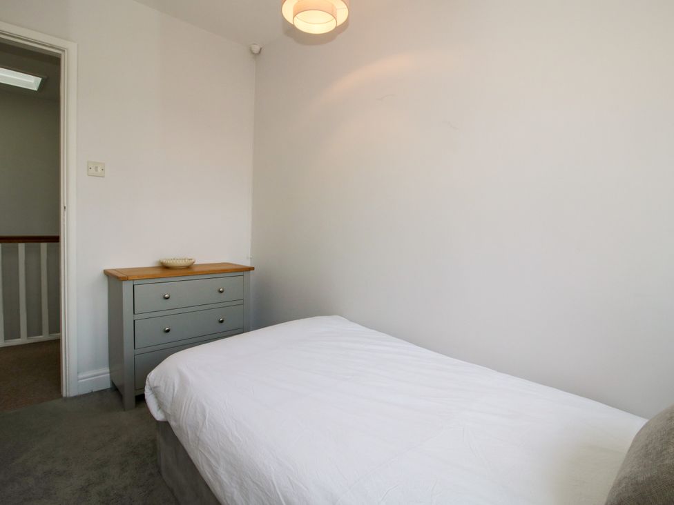 A bedroom with a bed and a drawer at Corner House in Minsterley