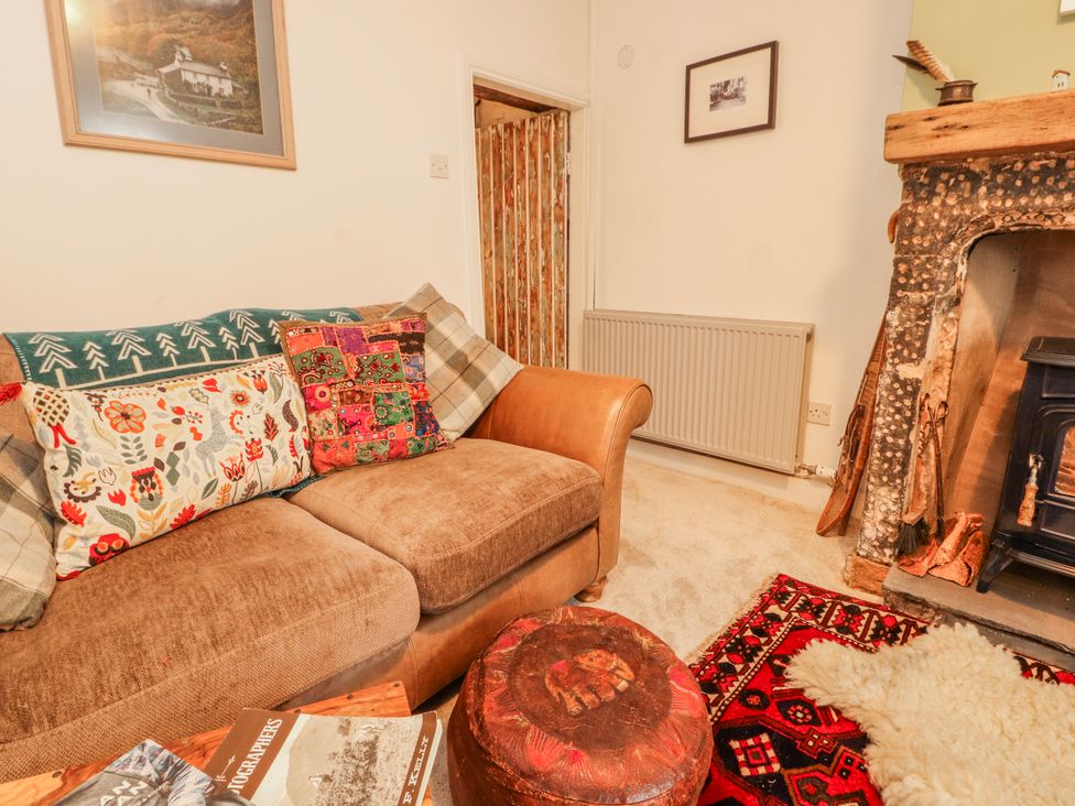 A living room with a sofa and fireplace at 25 Low Seaton in Workington