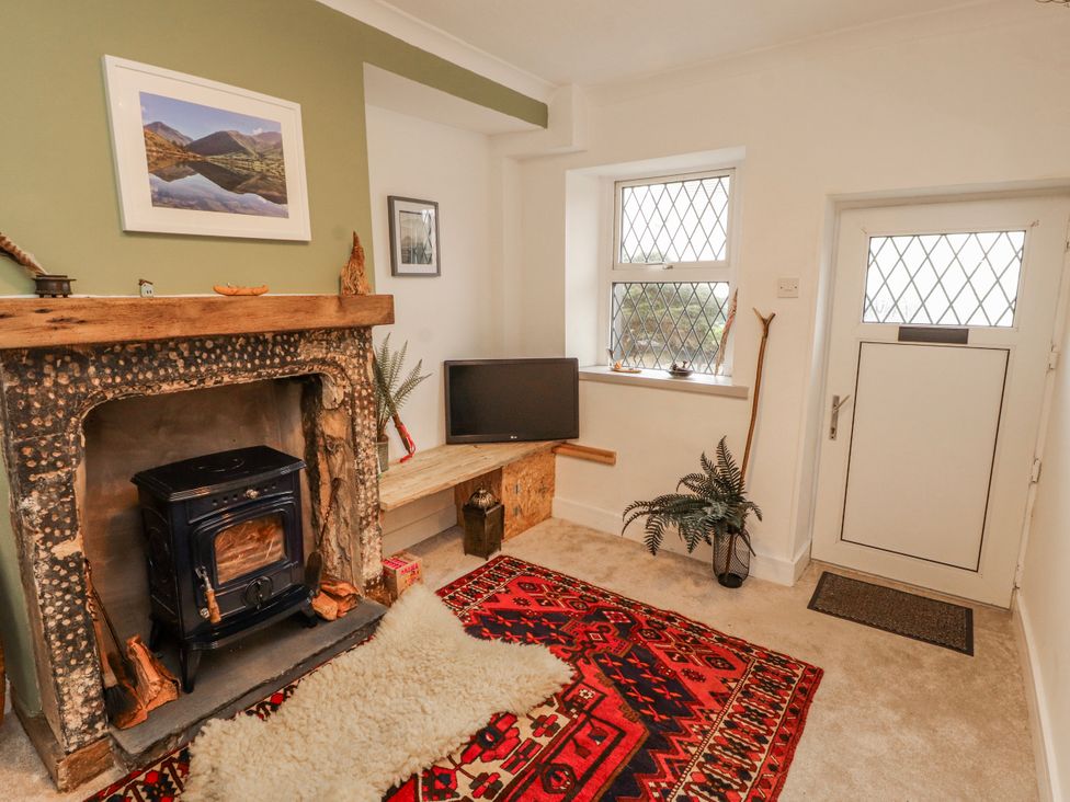 A living room with a fireplace and television at 25 Low Seaton in Workington