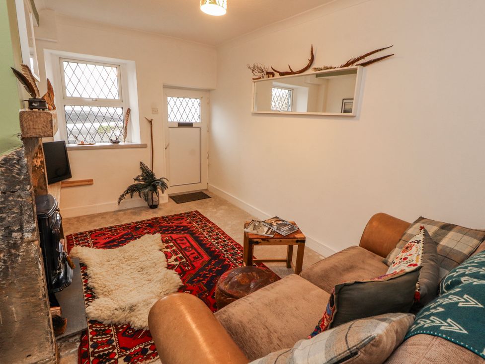 A living room with a sofa and a table at 25 Low Seaton in Workington