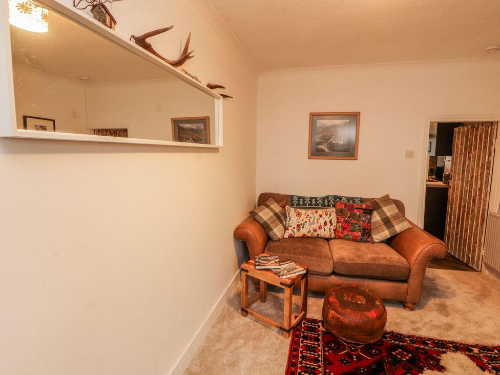 A living room with a sofa and table at 25 Low Seaton in Workington