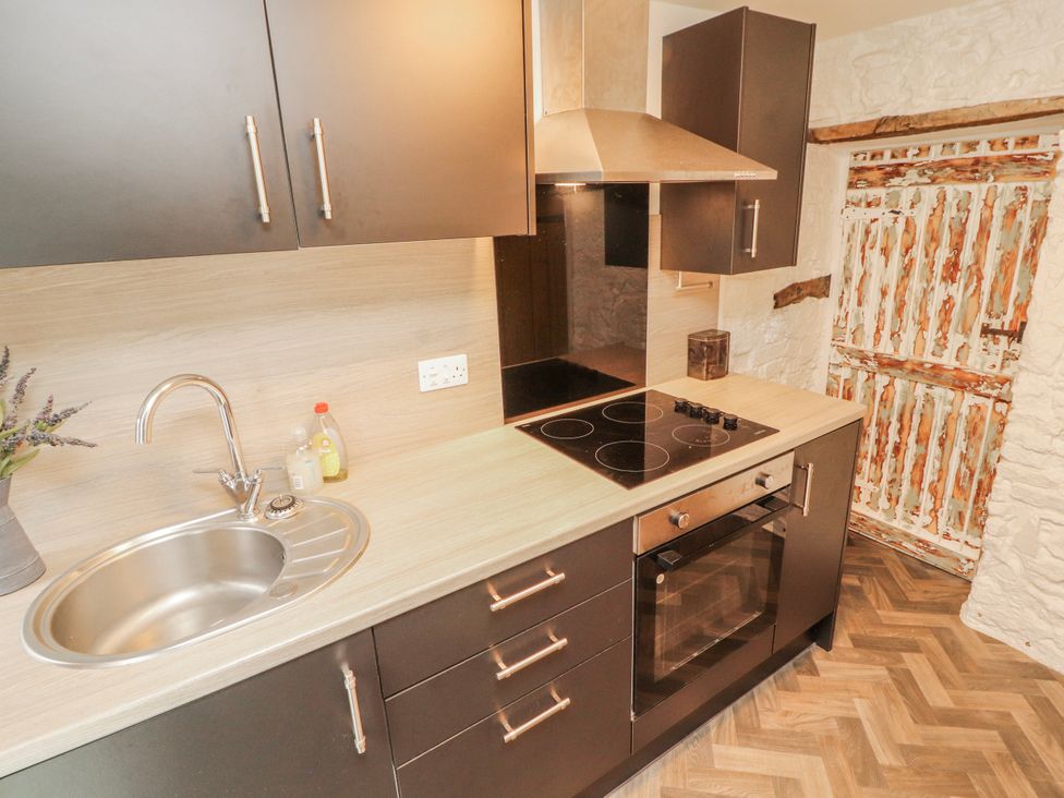 A kitchen with sink and oven at 25 Low Seaton in Workington