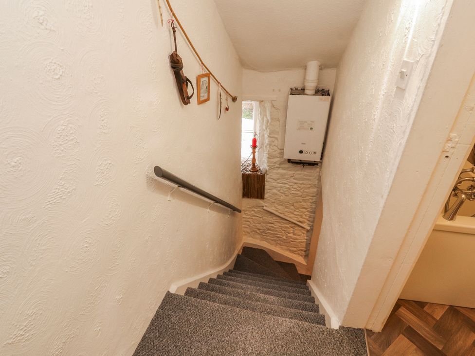 A staircase with handrail and boiler at 25 Low Seaton in Workington