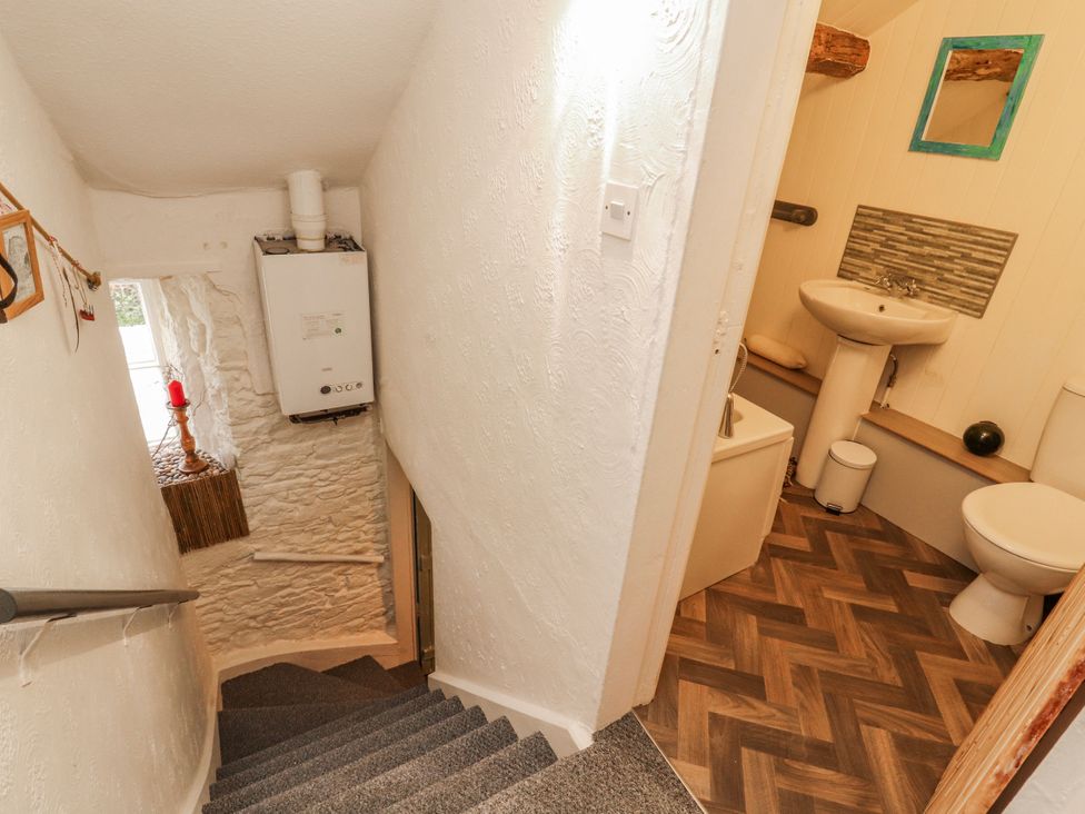 A staircase leading to a bathroom with a sink and toilet at 25 Low Seaton Workington