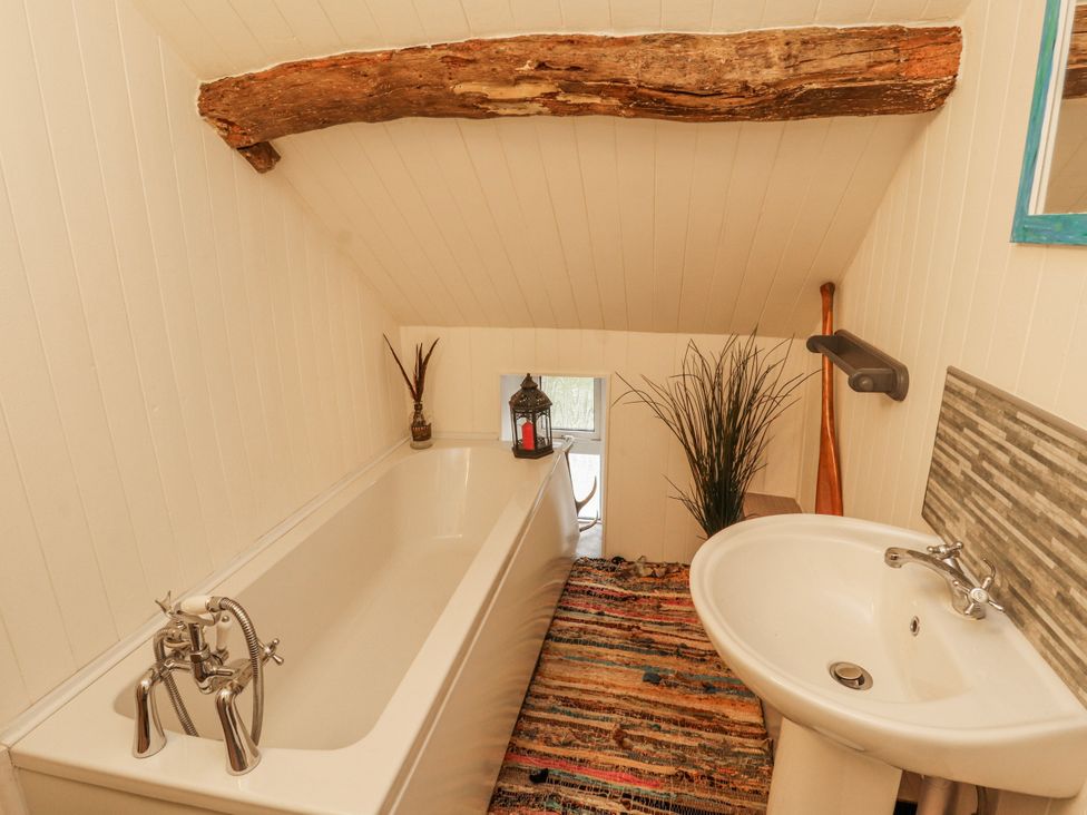 A bathroom with a bathtub and sink at 25 Low Seaton in Workington