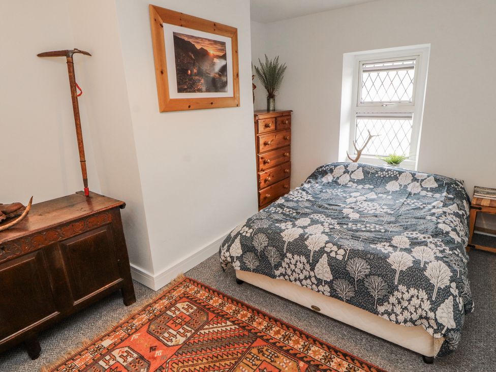 A bedroom with a bed and wooden furniture at 25 Low Seaton Workington