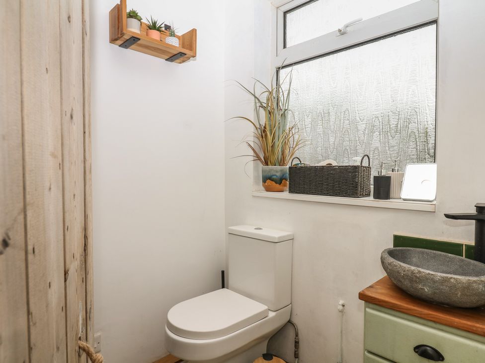 A bathroom with a toilet and sink at Bedford Cottage in Yelverton