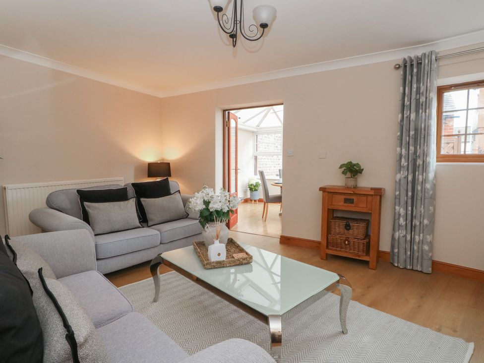 A living room with a sofa and coffee table at 1 The Stables Wrexham
