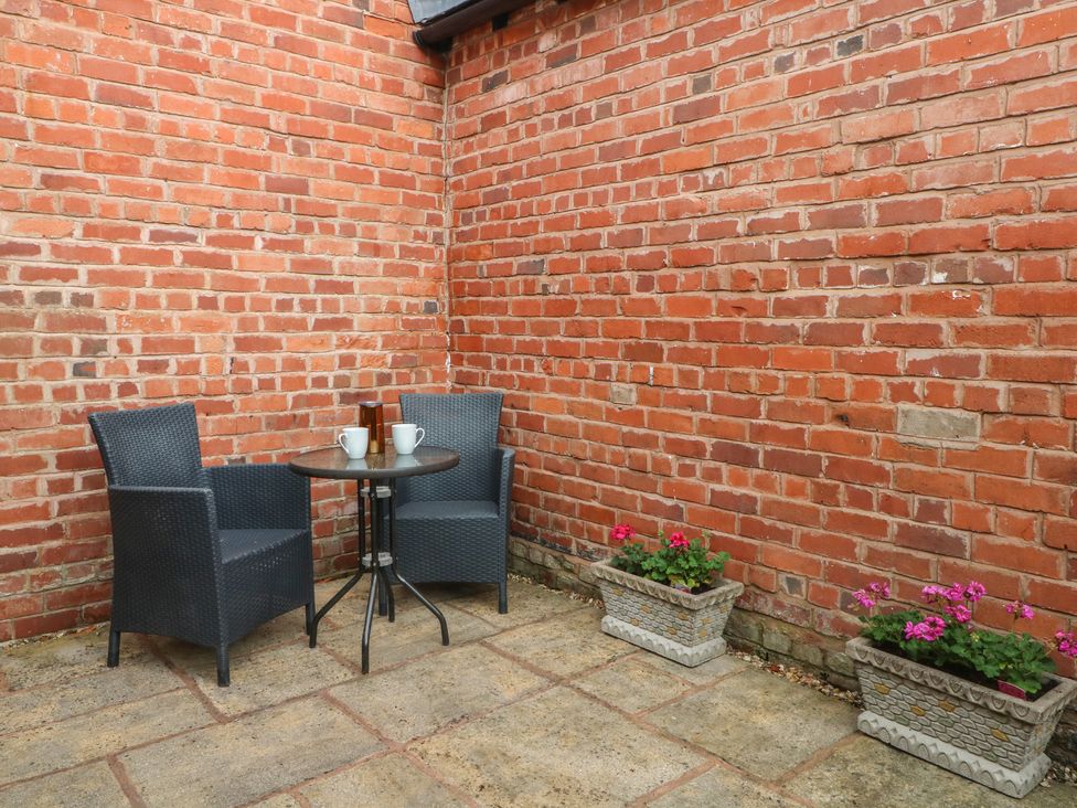 A garden area with a table and chairs at 1 The Stables Wrexham