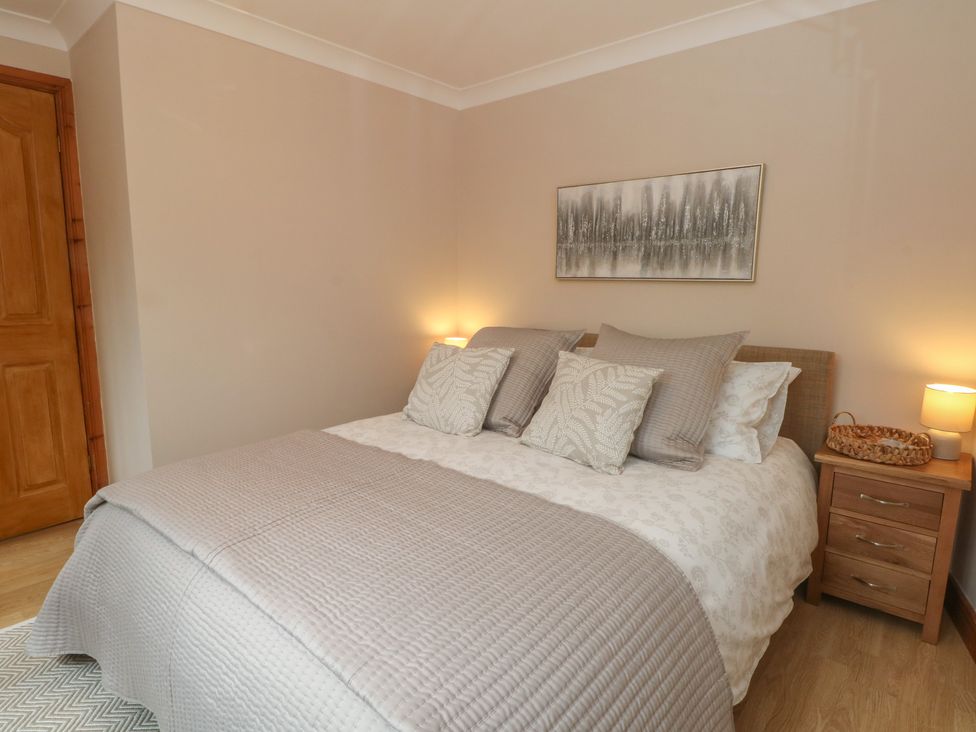 A bedroom with a bed and bedside table at 1 The Stables in Rossett