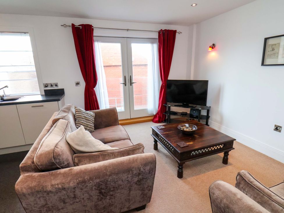 A living room with a sofa and coffee table at Apartment 12 