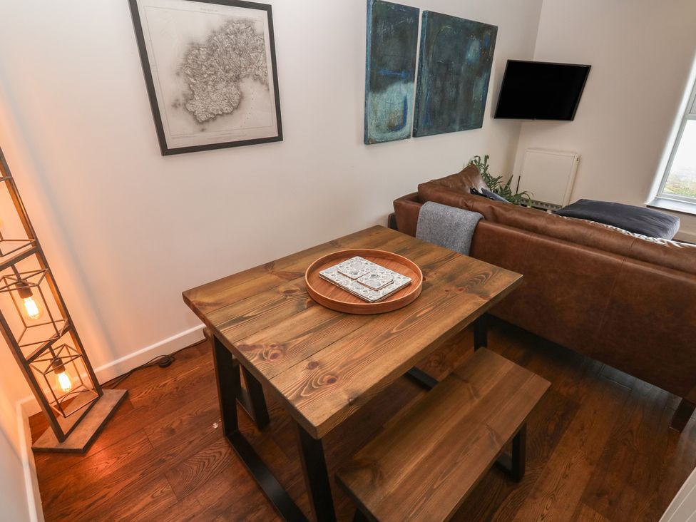 A dining area with a table and benches at Cape View near St Just