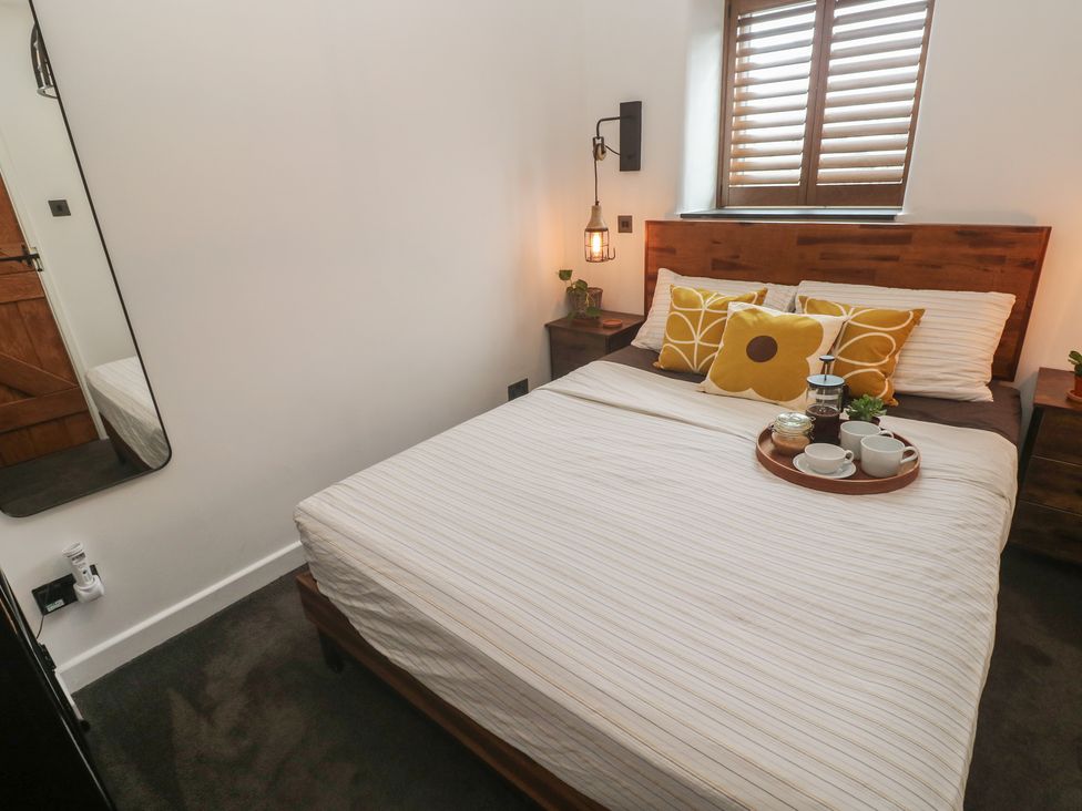 A bedroom with a bed and tray of drinks at Cape View Cape Cornwall near St Just