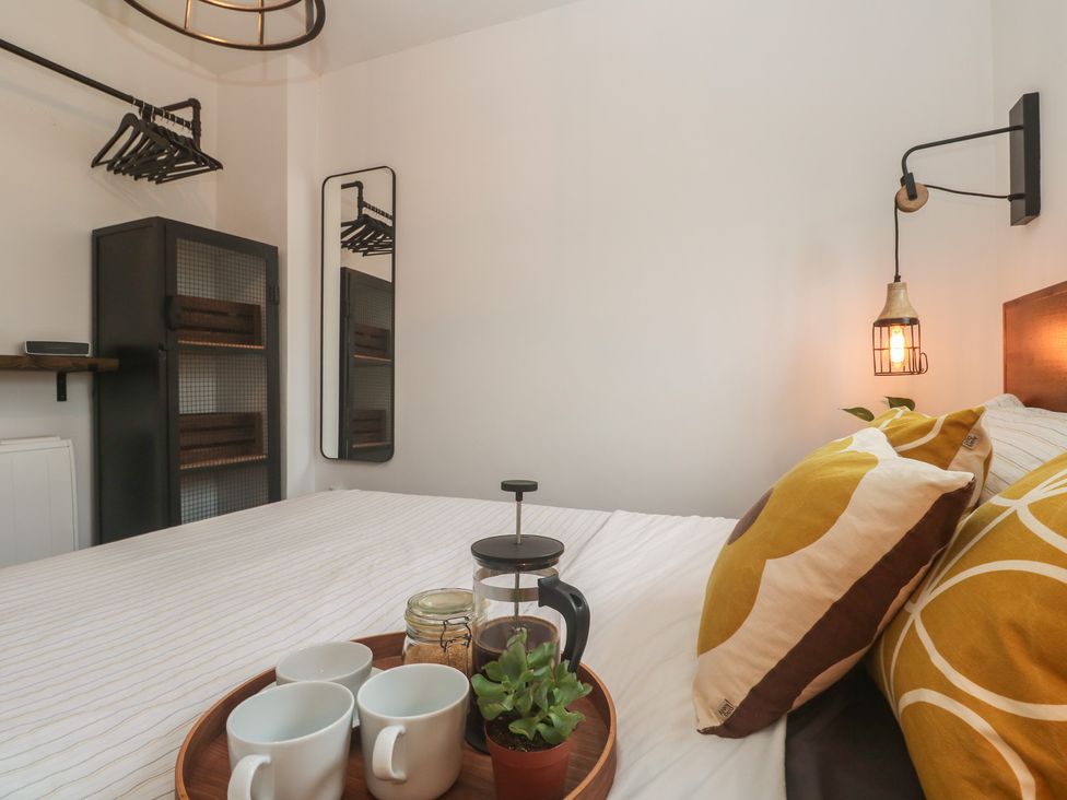 A bedroom with a bed and decorative pillows at Cape View in Cape Cornwall near St Just