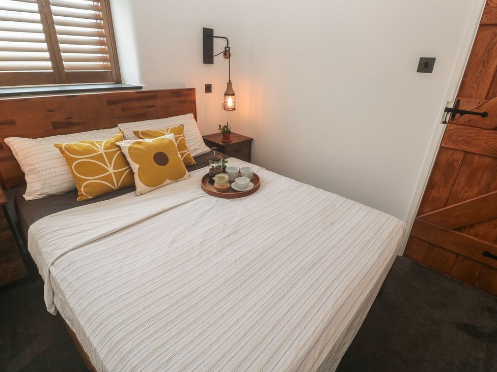 A bedroom with a bed and nightstand at Cape View in Cape Cornwall near St Just