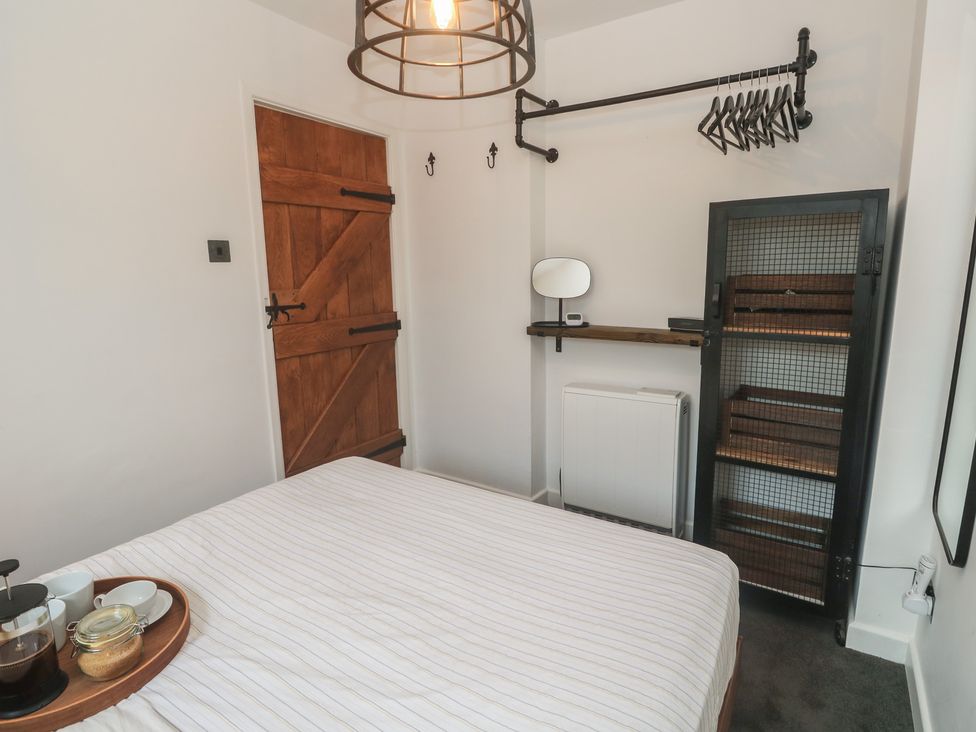 A bedroom with a bed and a storage unit at Cape View in Cape Cornwall near St Just