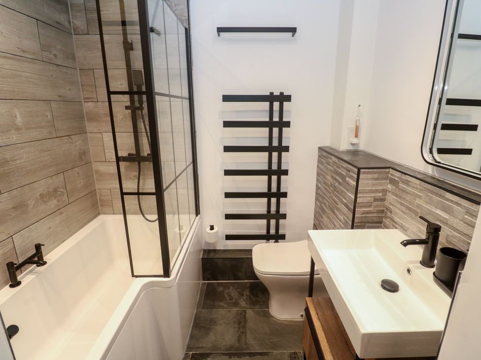 A bathroom with bathtub, shower enclosure, sink, and toilet at Cape View near Cape Cornwall