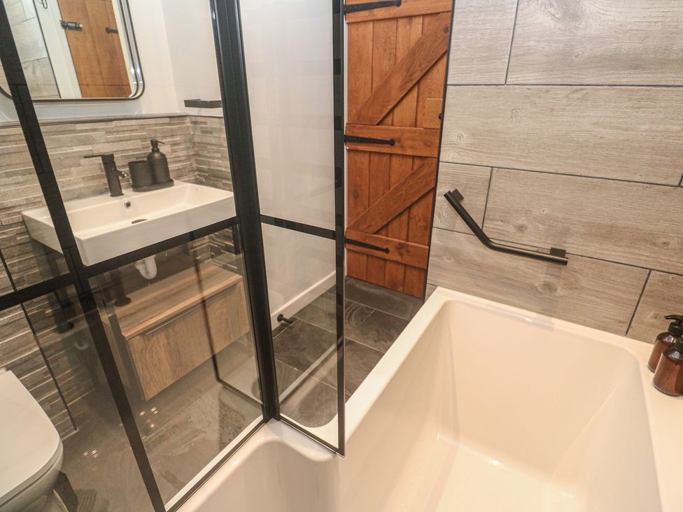 A bathroom with a shower, bathtub and sink at Cape View Cape Cornwall near St Just