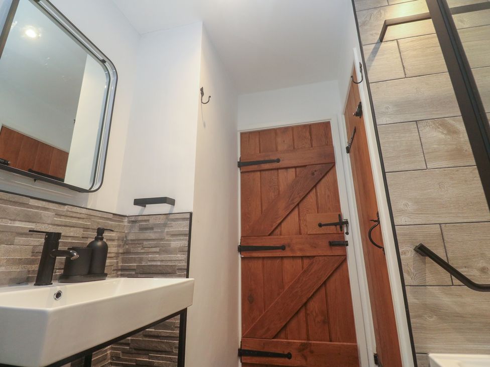 A bathroom with a sink and mirror at Cape View in Cape Cornwall near St Just