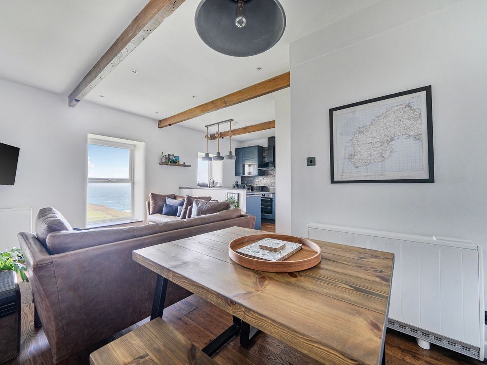 A living room with a sofa and table at Cape View near St Just