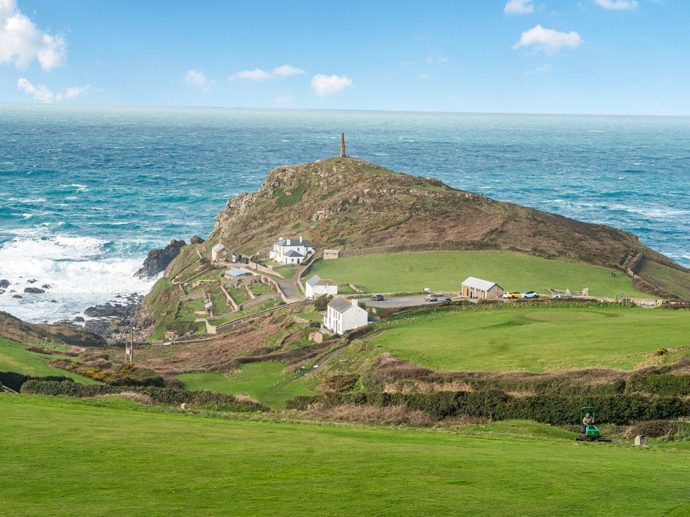 A coastal view with houses and a hill near the ocean at Cape View in Cape Cornwall near St Just