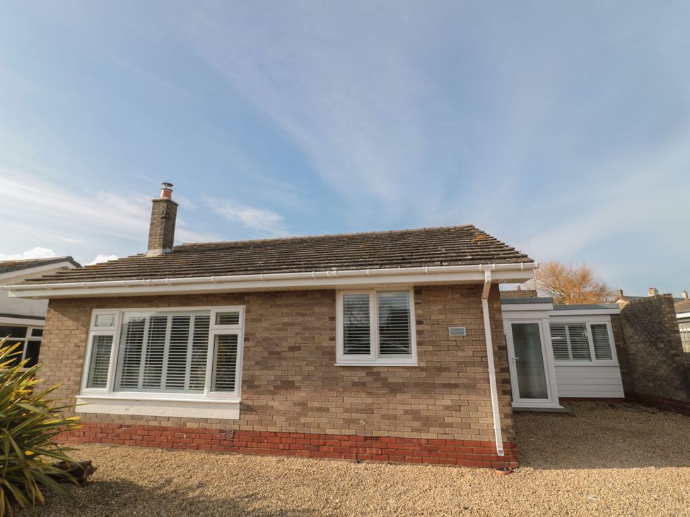 A bungalow exterior with windows and a gravel driveway at 7 Longstone Close Chathill