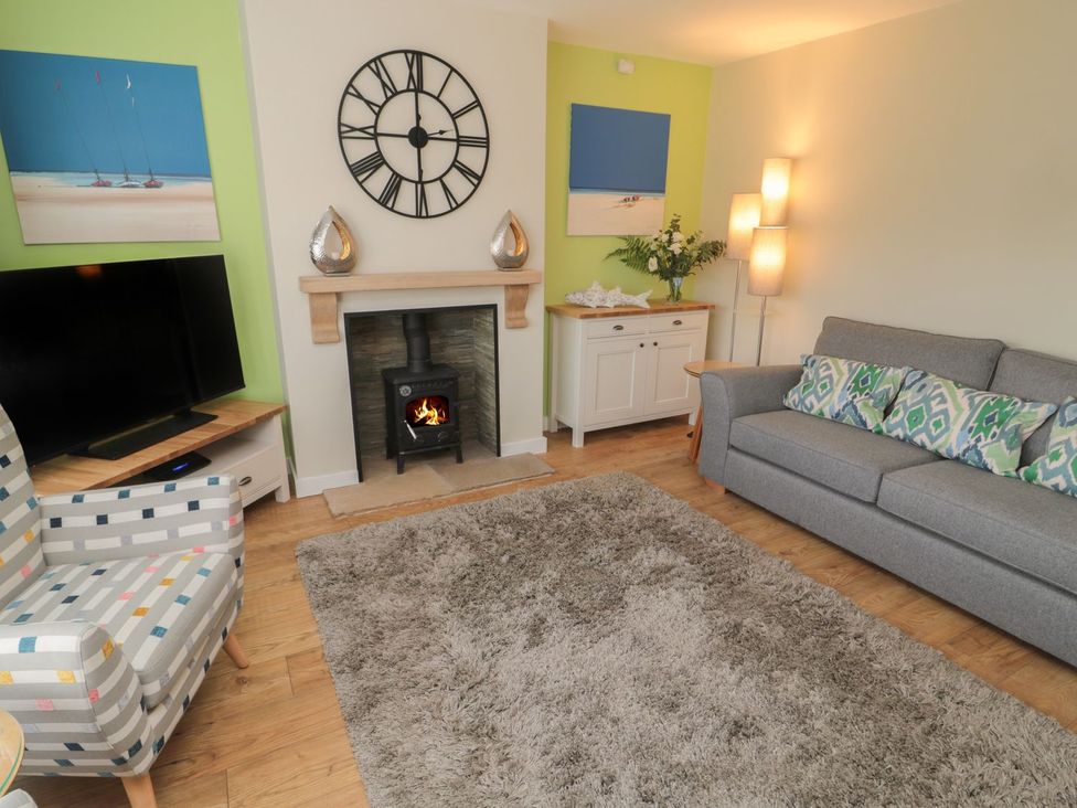 A living room with a sofa and a fireplace at 7 Longstone Close Chathill