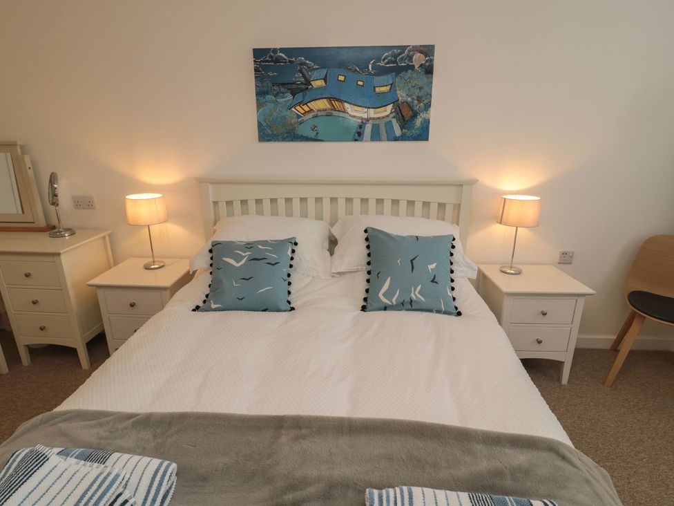 A bedroom with a bed and bedside tables at 7 Longstone Close in Chathill