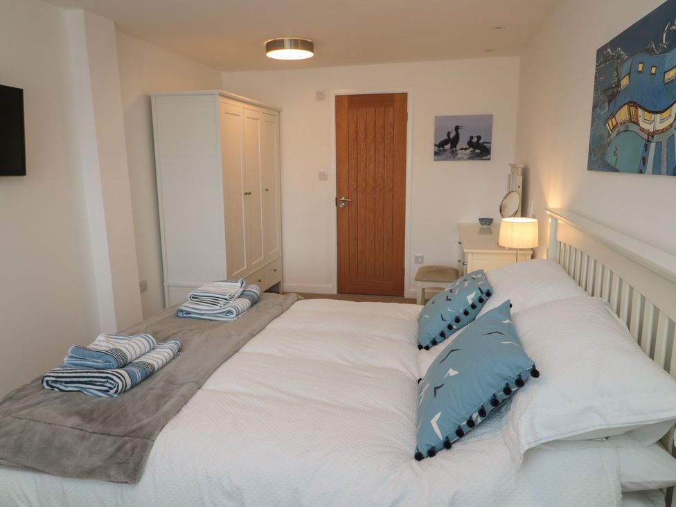 A bedroom with a bed and wardrobe at 7 Longstone Close in Chathill