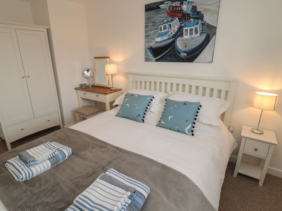A bedroom with a bed and wardrobe at 7 Longstone Close in Chathill
