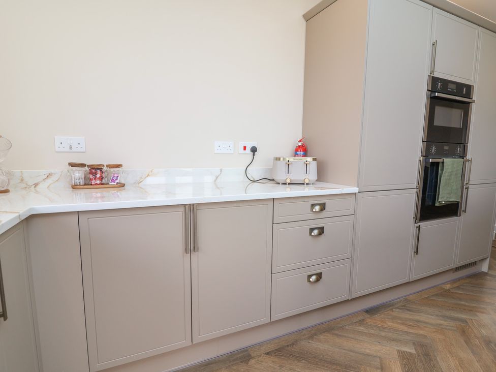 A kitchen with cabinets and countertop at Bella Vista in Deganwy