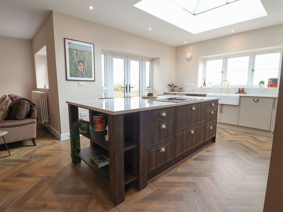 A kitchen with an island and a sink at Bella Vista in Deganwy