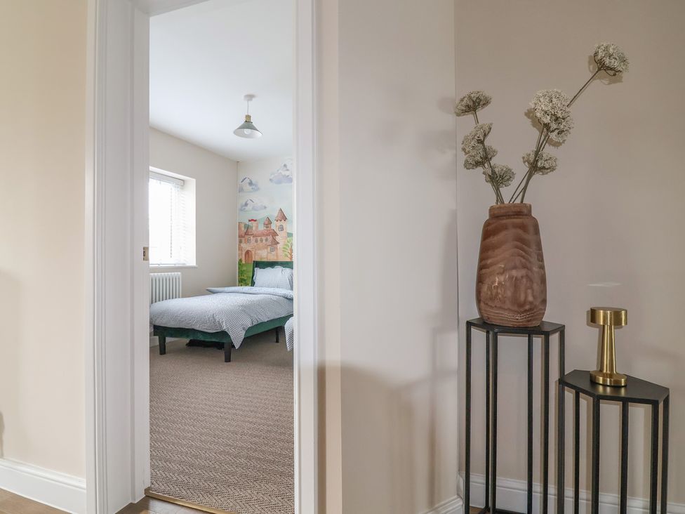 A bedroom with a bed and decorative items at Bella Vista in Deganwy