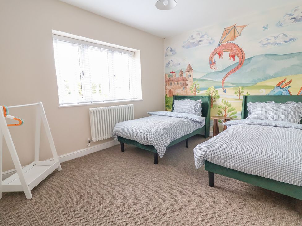 A bedroom with two beds and a wall mural at Bella Vista in Deganwy