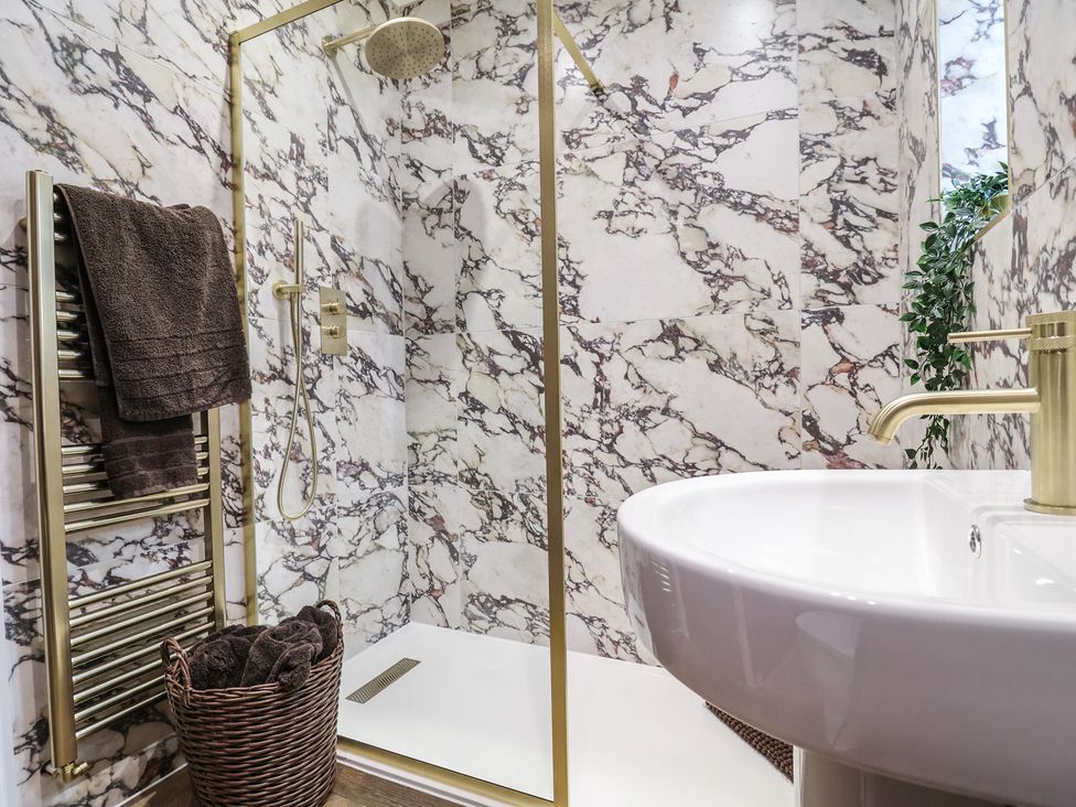 A bathroom with a shower and sink at Bella Vista in Deganwy