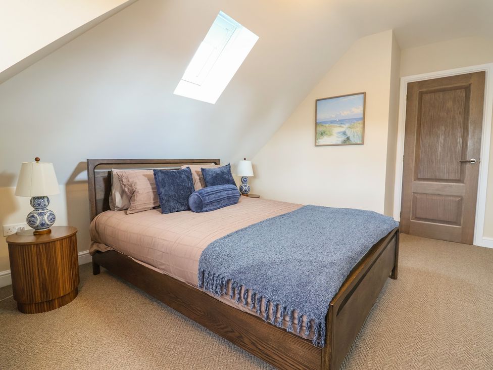 A bedroom with a bed and bedside table at Bella Vista in Deganwy