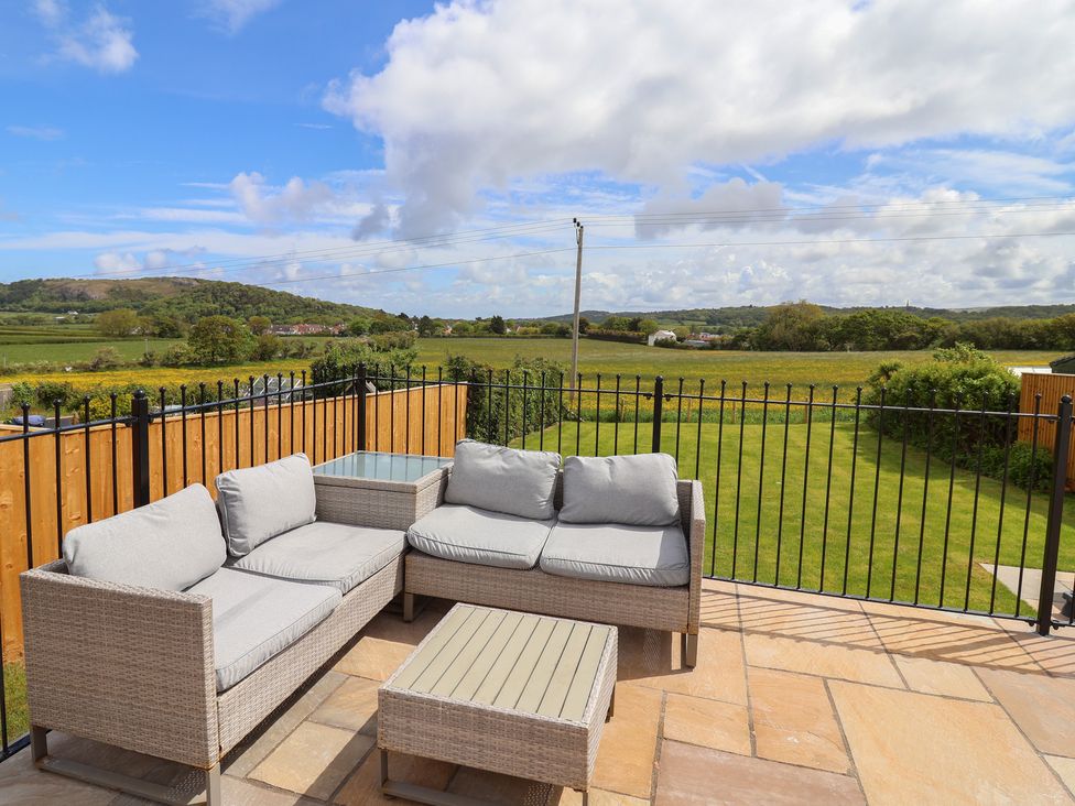 An outdoor seating area with a sofa and coffee table at Bella Vista in Deganwy