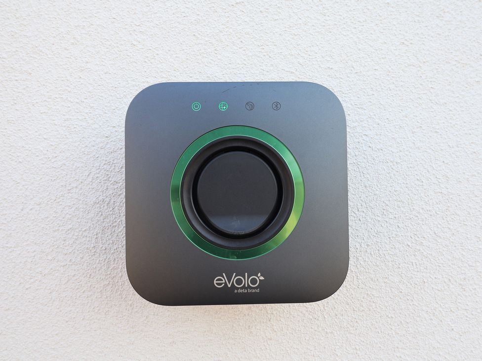A device with buttons and LED indicators mounted on a wall at Bella Vista in Deganwy