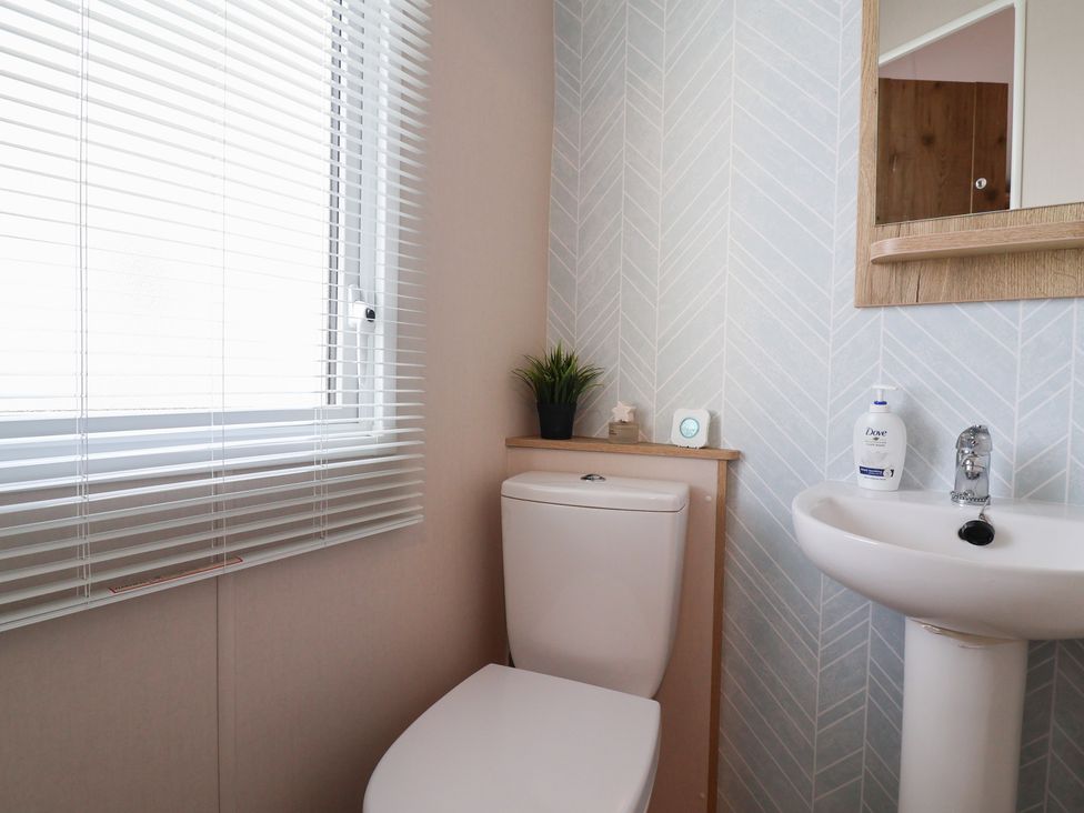 A bathroom with a sink and toilet at Caravan Woodlands Hall Caravan Park near Ruthin