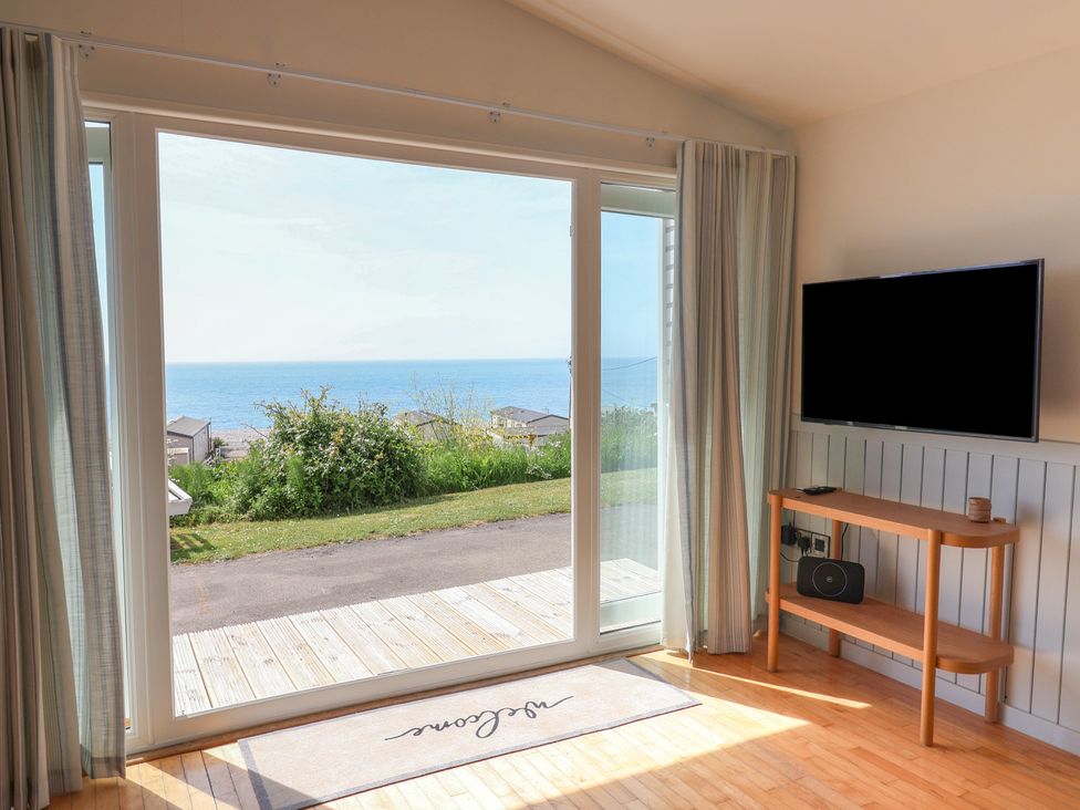 A living room with a view of the sea at Salt & Stone in Lyme Regis