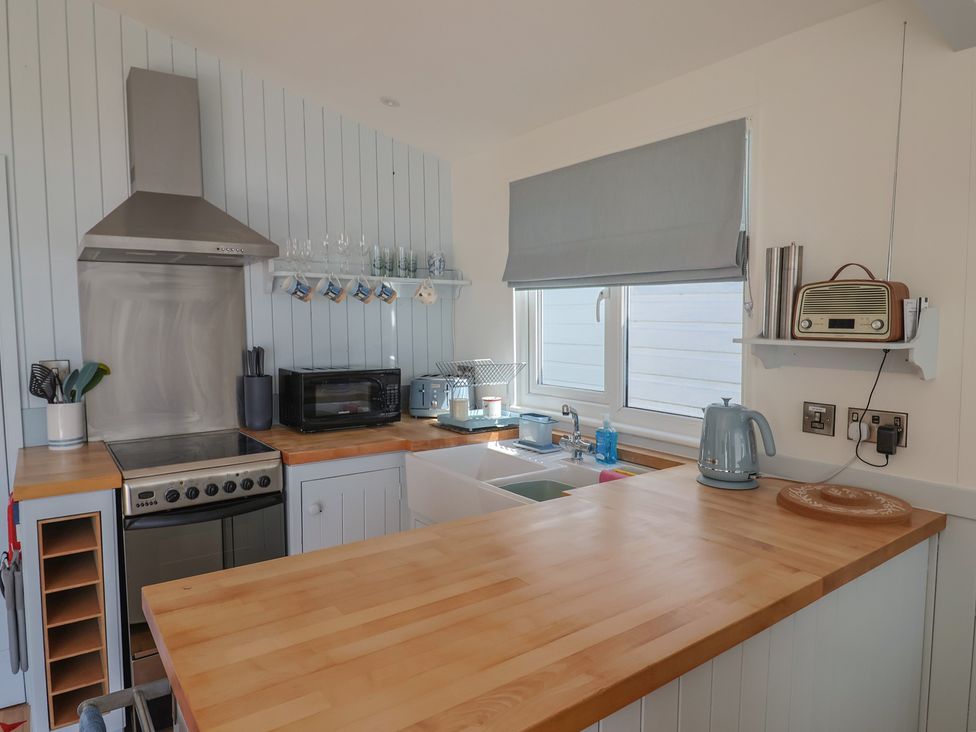 A kitchen with an oven and sink at Salt & Stone in Lyme Regis