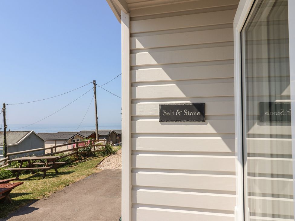 A view of the exterior signage for Salt & Stone in Lyme Regis
