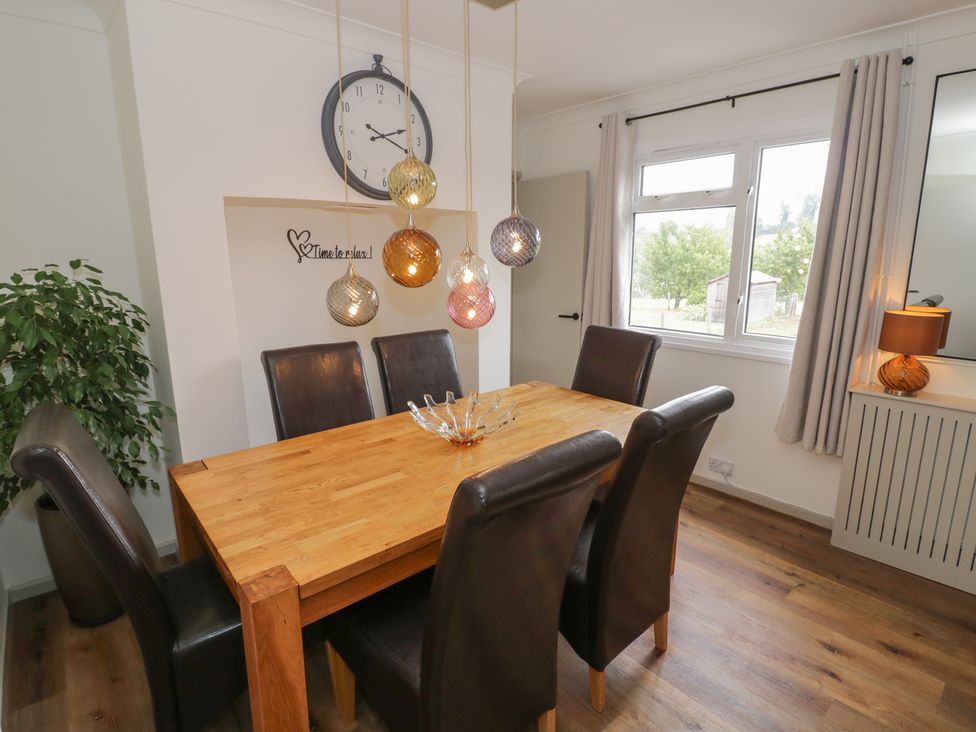 A dining room with a wooden table and chairs at 3 Swedish House Walgrave