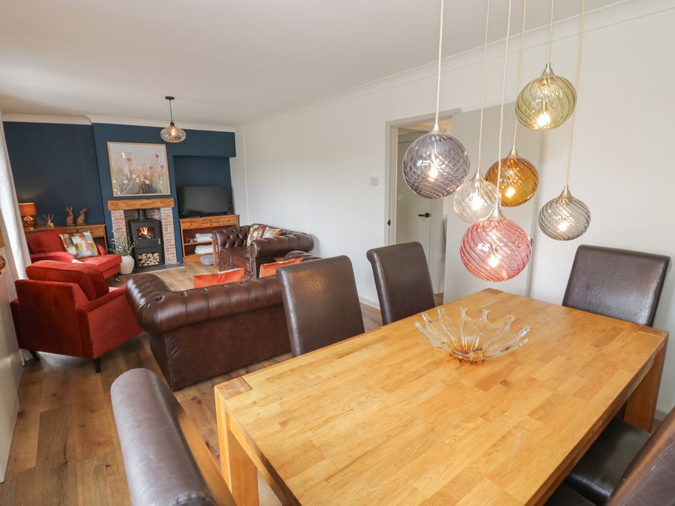 A living room with a sofa and dining table at 3 Swedish House in Walgrave