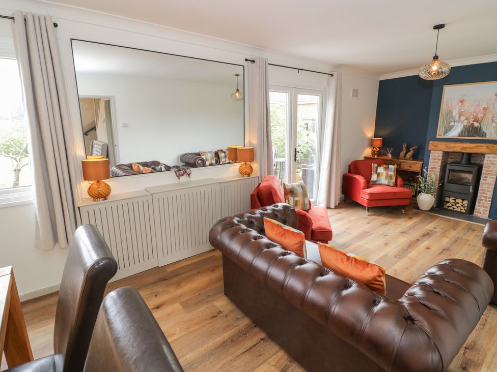 A living room with a mirror and furniture at 3 Swedish House Walgrave
